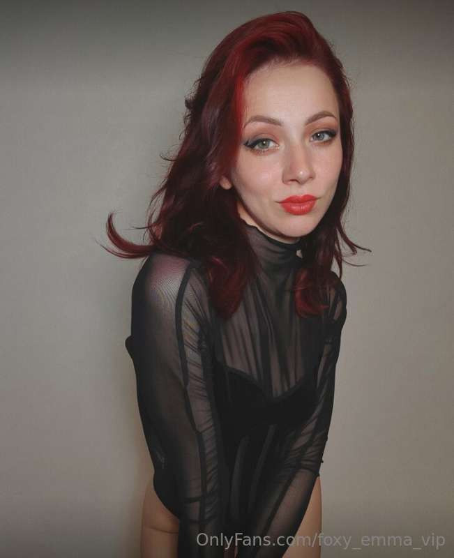 Wrapped in the sultry embrace of midnight black, your figure..