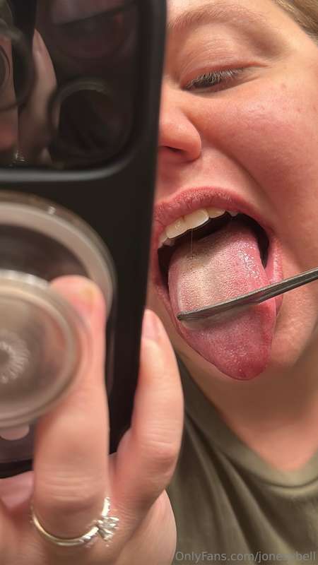 Using the handle of a spoon to scrape my tongue and show off..