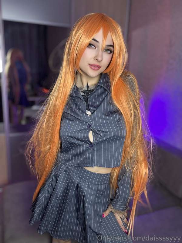 Long fiery hair, a playful smirk, and just enough undone but..