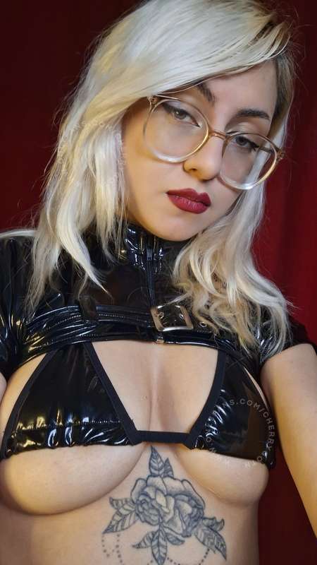 Blonde bombshell walking on killer heels, fishnets and red l..