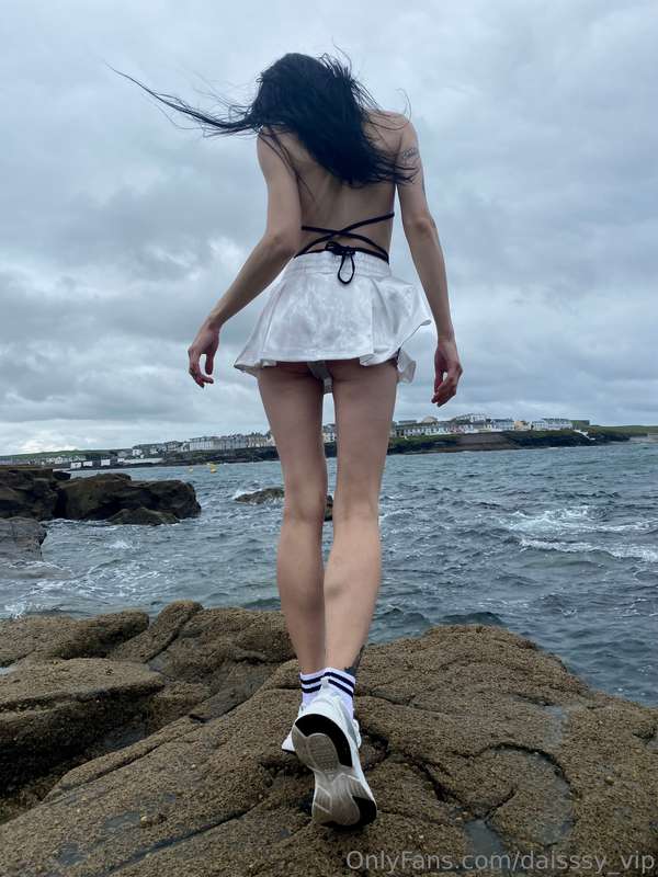 Amidst the roaring abyss, I stand by the brooding sea in a d..
